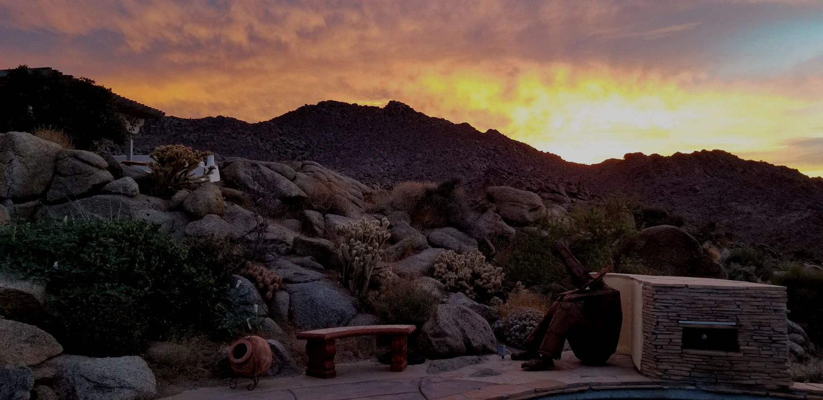 Sunset over the estate’s pool and rock formations